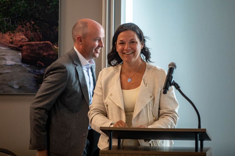 Catherine Raney Norman, chairwoman of the Salt Lake
City-Utah Committee for the Games, speaks as Gov. Spencer Cox walks
by during a meeting of the Salt Lake City-Utah Committee for the
Games at the Element Event Center near the Utah Olympic Oval in
Kearns on Thursday June 10, 2021.