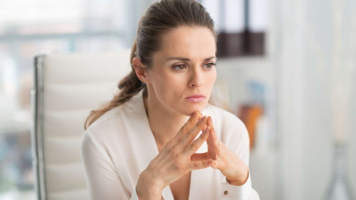 A woman looks thoughtful and concerned. In this edition of LIFEadvice, Coach Kim shares some secrets to making tough choices easier.