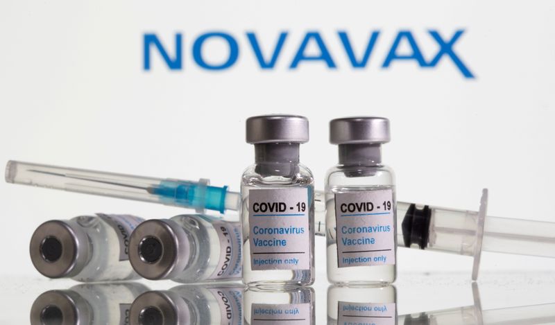 FILE PHOTO: Vials labelled "COVID-19 Coronavirus Vaccine" and syringe are seen in front of displayed Novavax logo in this illustration taken, February 9, 2021.  