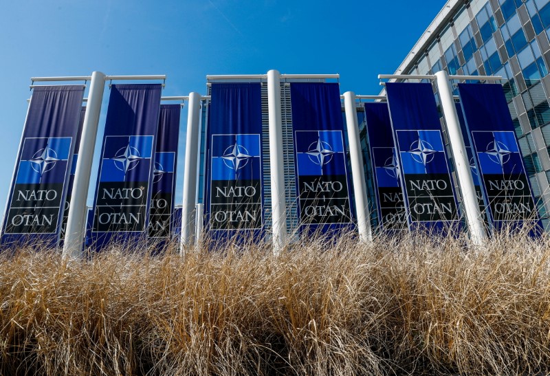 FILE PHOTO: Banners displaying the NATO logo are placed at the entrance of new NATO headquarters during the move to the new building, in Brussels, Belgium April 19, 2018.