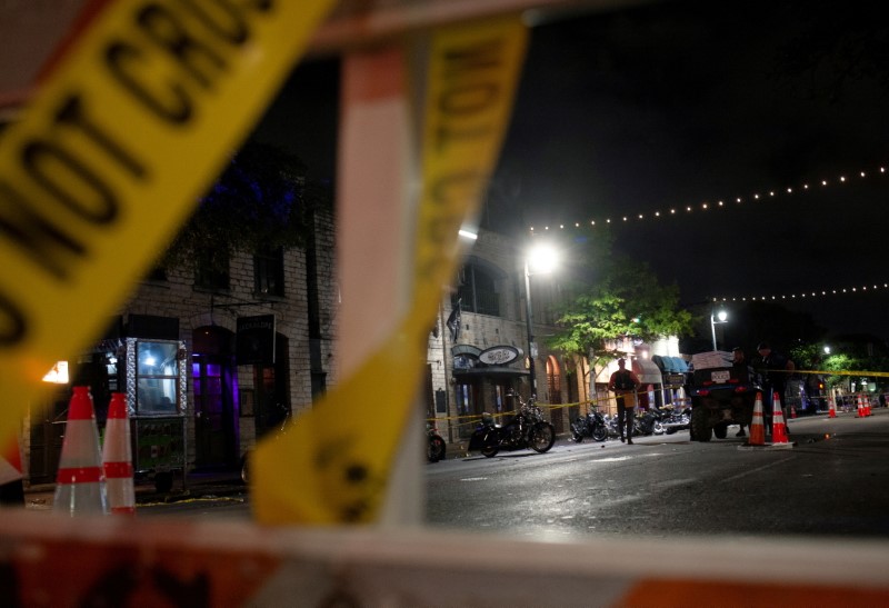 FILE PHOTO: Police investigate the scene of a mass shooting in the Sixth Street entertainment district area of Austin, Texas, U.S. June 12, 2021. REUTERS/Nuri Vallbona/File Photo