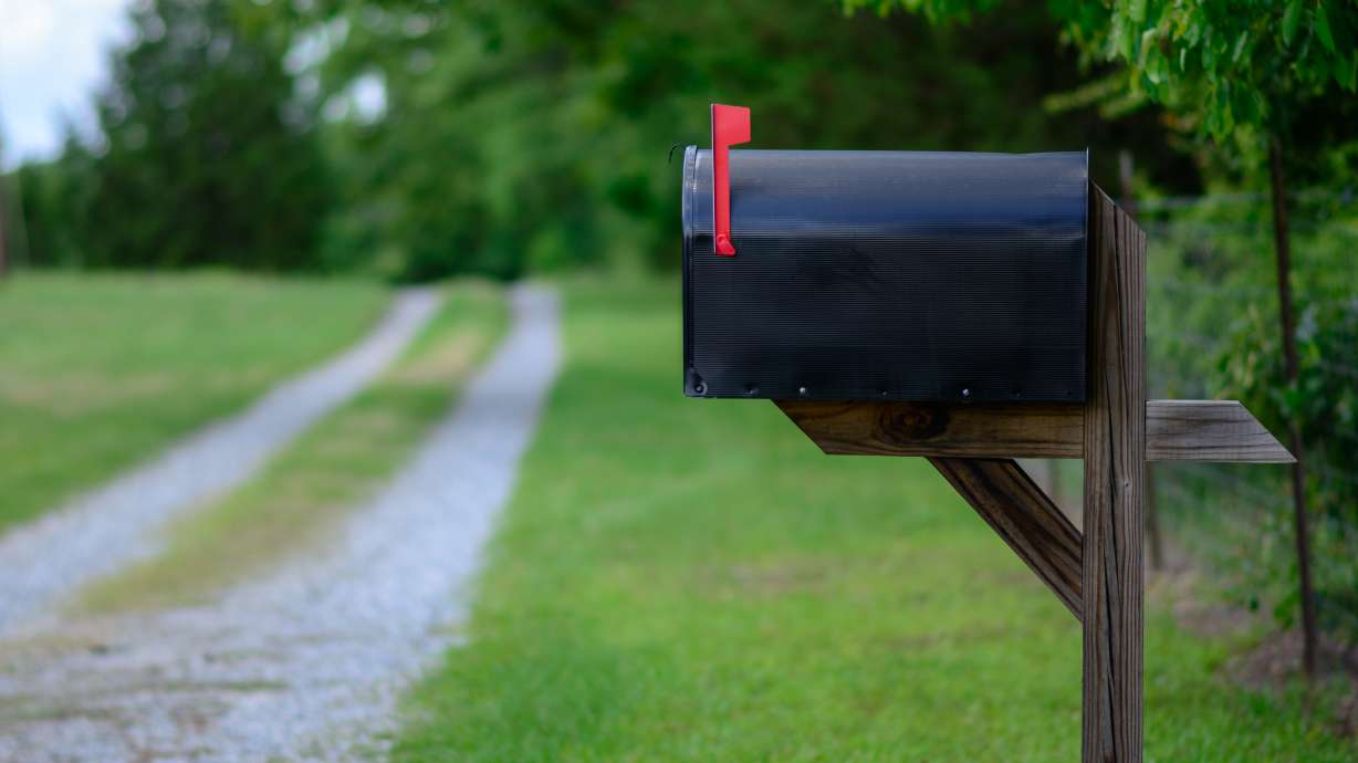 A mailbox with its flag up sits along a road. The the U.S. Postal Service ranks Salt Lake 25th for number of dog bites to mail carriers in 2020.