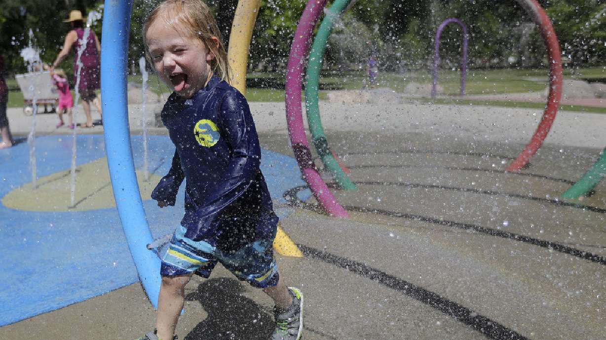 Miles Rosenberg cools off in the splash pad at Liberty Park during a heat wave in Salt Lake City on June 14.