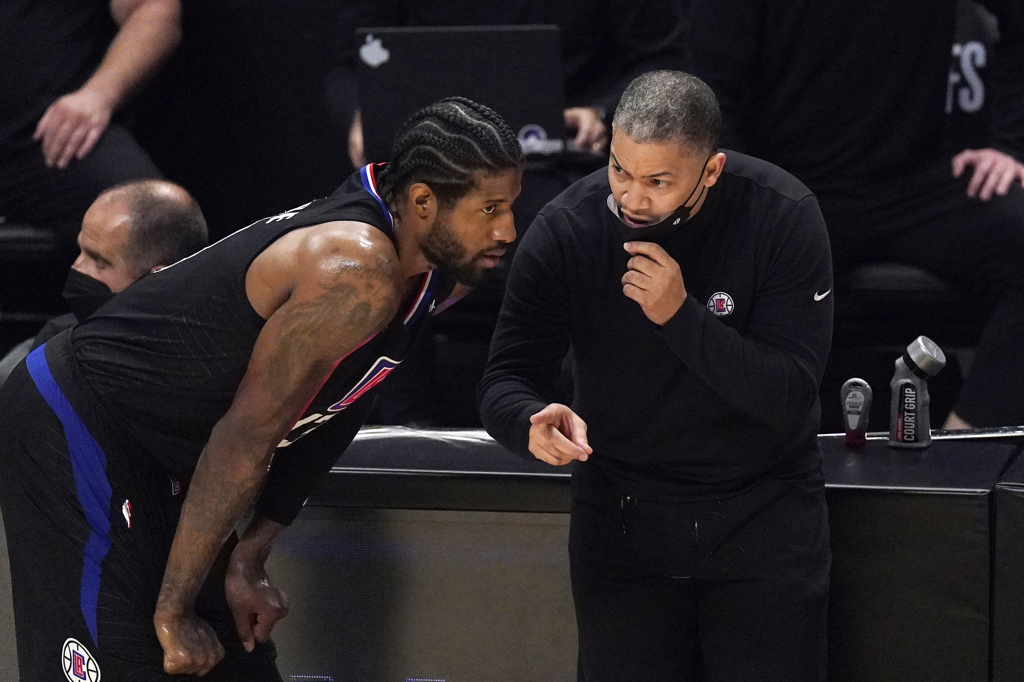 Los Angeles Clippers head coach Tyronn Lue, right, talks with guard Paul George during the first half in Game 4 of a second-round NBA basketball playoff series against the Utah Jazz Monday, June 14, 2021, in Los Angeles.