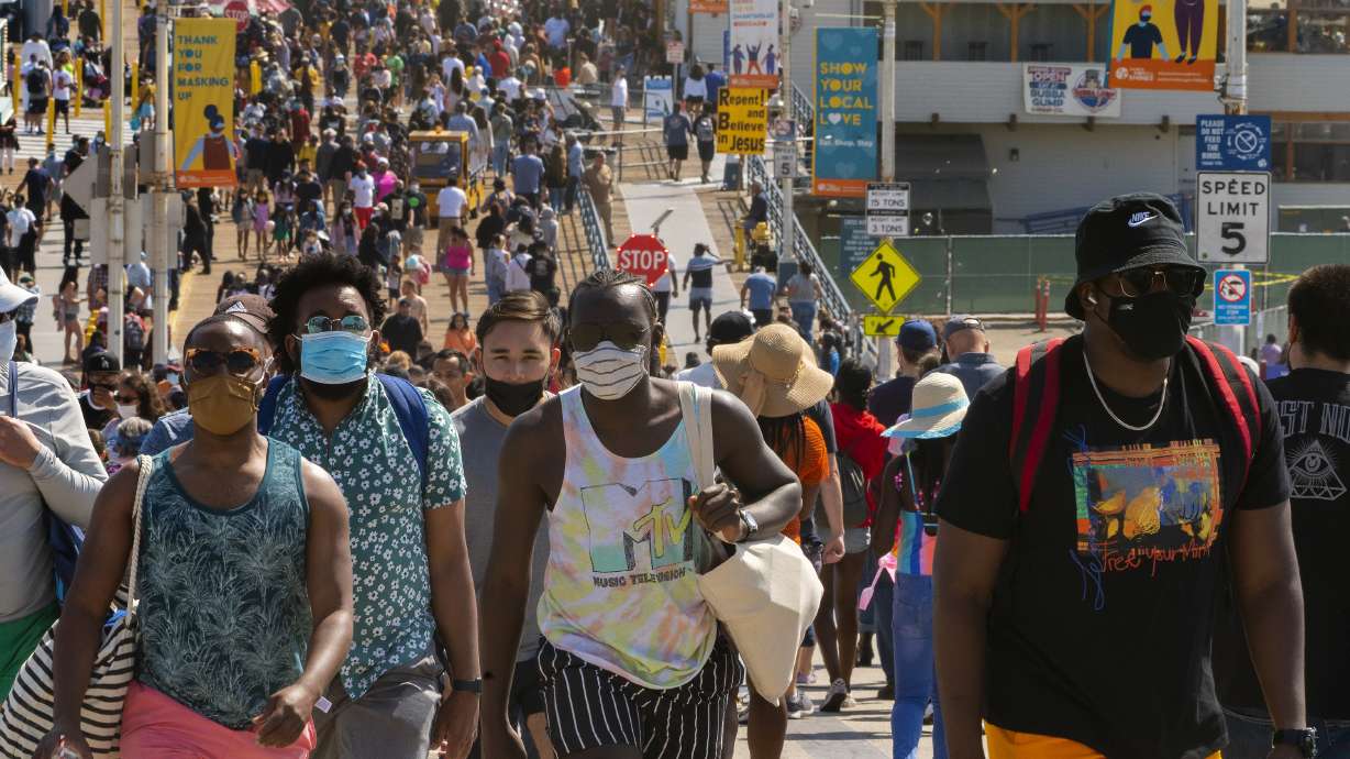 In this Saturday, May 29, 2021, file photo, people crowd the Santa Monica Pier in Santa Monica, Calif. California, the first state in America to put in place a coronavirus lockdown, is now turning a page on the pandemic. Most of California's coronavirus restrictions will disappear Tuesday, June 15, 2021.