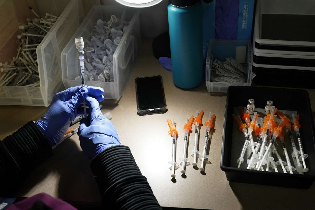 Registered nurse fills syringes with Pfizer vaccines at a COVID-19 vaccination clinic in Bellingham, Wash. The U.S. death toll from COVID-19 has topped 600,000, even as the vaccination drive has drastically slashed daily cases and deaths and allowed the country to emerge from the gloom. (Elaine Thompson, Associated Press)