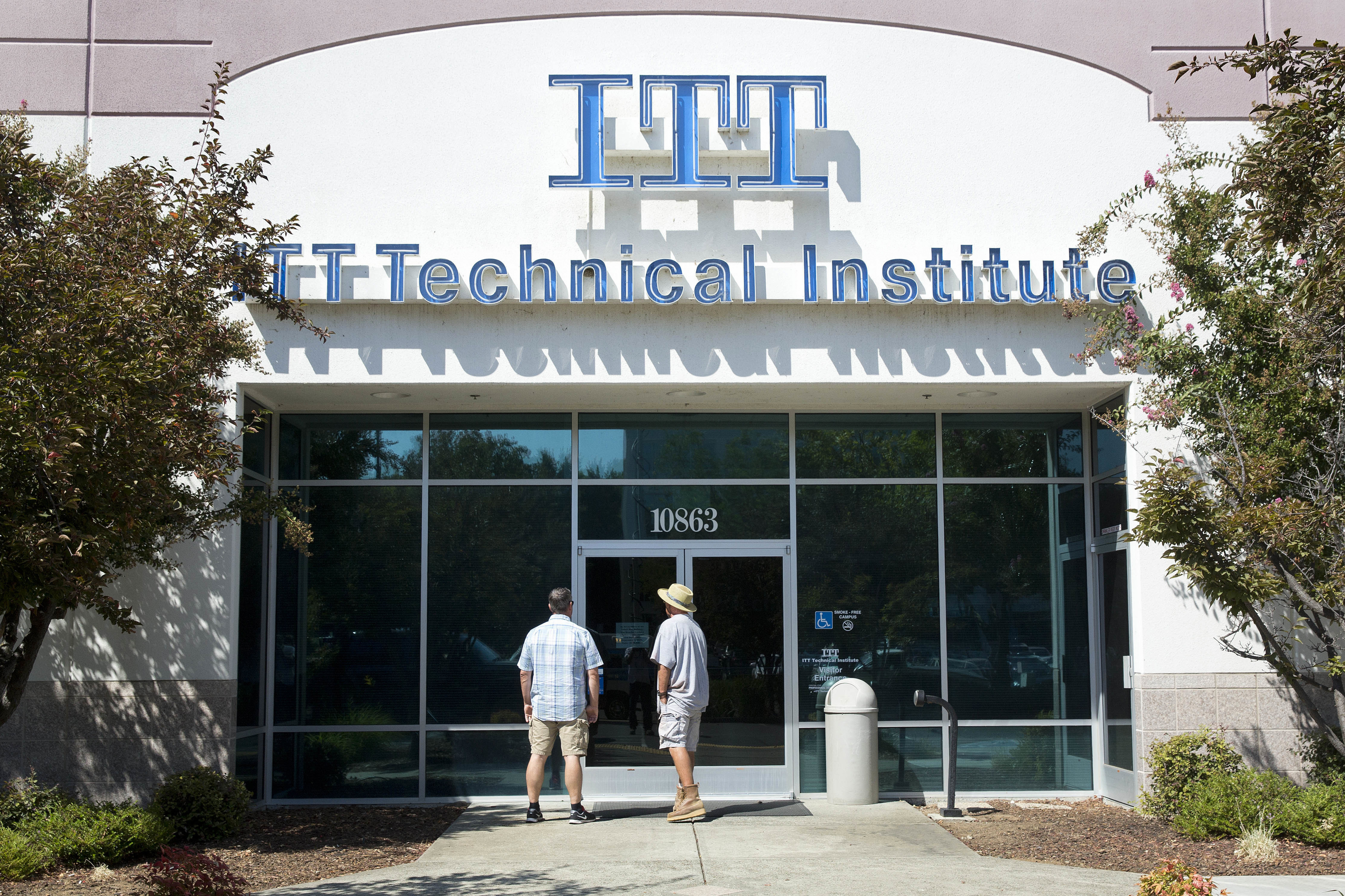 Students find the doors locked to the ITT Technical Institute campus in Rancho Cordova, Calif. The U.S. Education Department says it's erasing student debt for thousands of borrowers who attended a for-profit college chain that made exaggerated claims about its graduates' success in finding jobs.