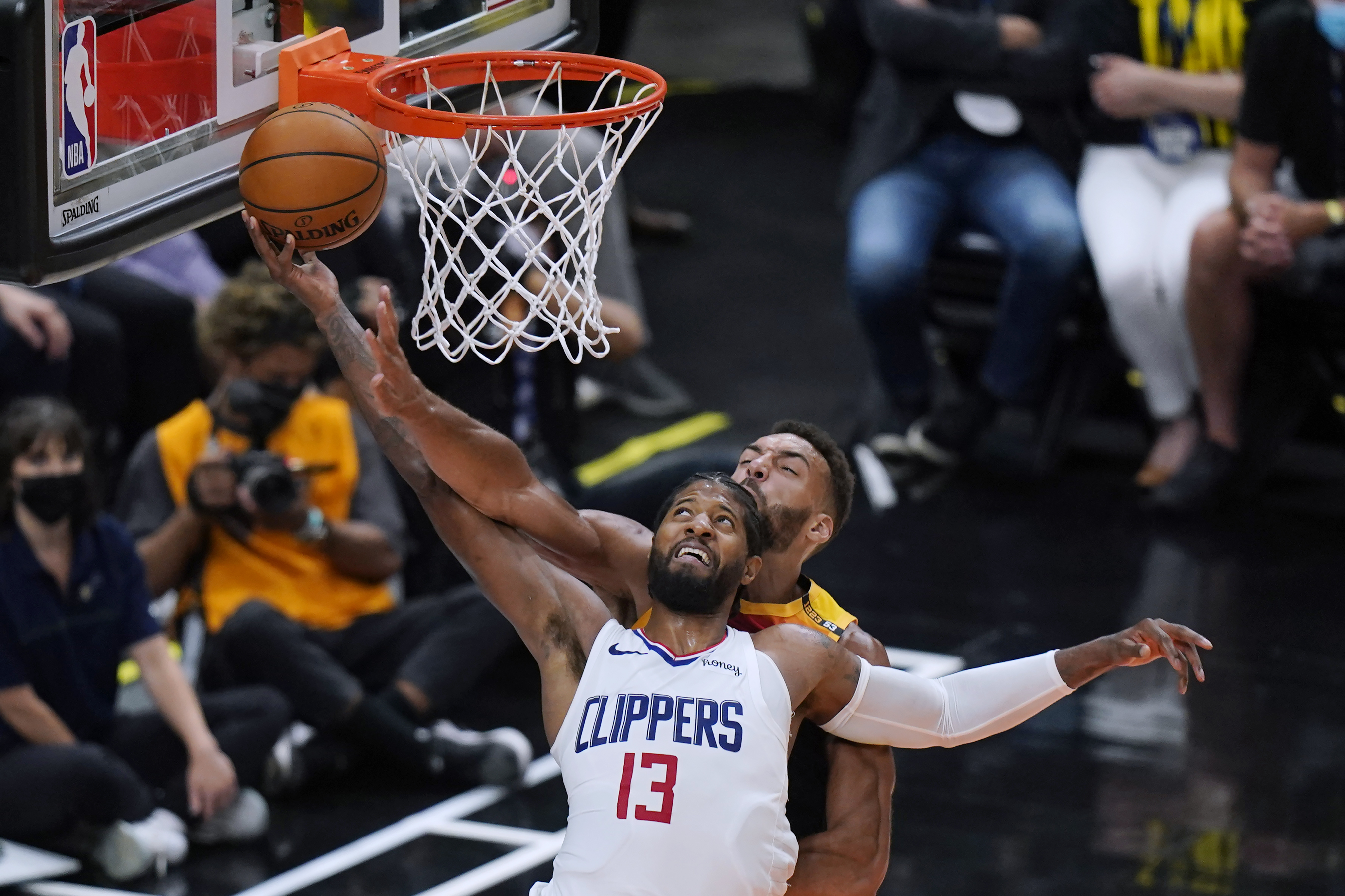 Utah Jazz center Rudy Gobert, rear, defends against Los Angeles Clippers guard Paul George (13) during the second half of Game 5 of a second-round NBA basketball playoff series Wednesday, June 16, 2021, in Salt Lake City.