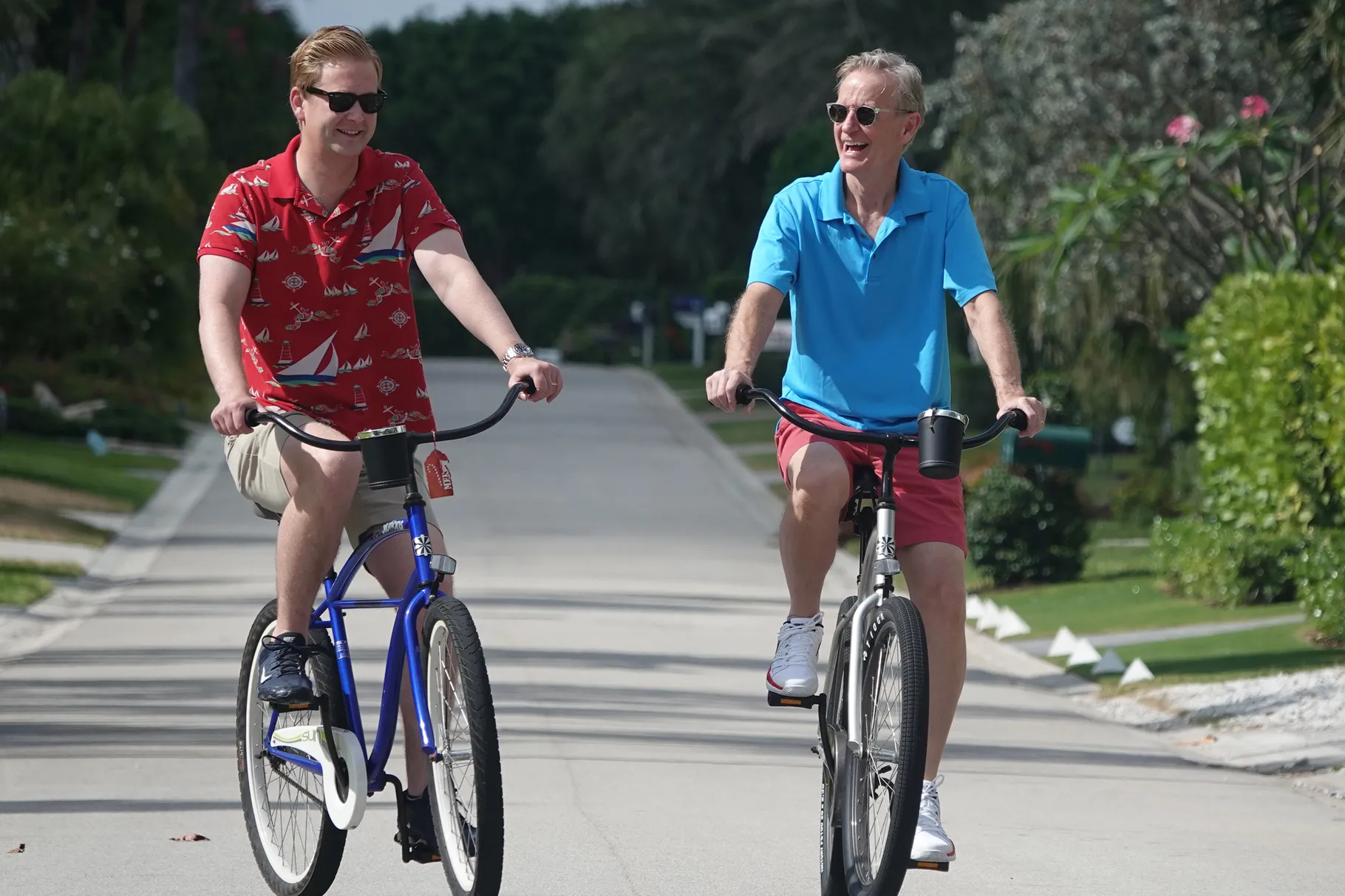 Peter Doocy, a Fox News White House correspondent, left, and his father Steve, right, of “Fox & Friends,” ride bicycles near the family home in Florida on Saturday, May 29, 2021. 

