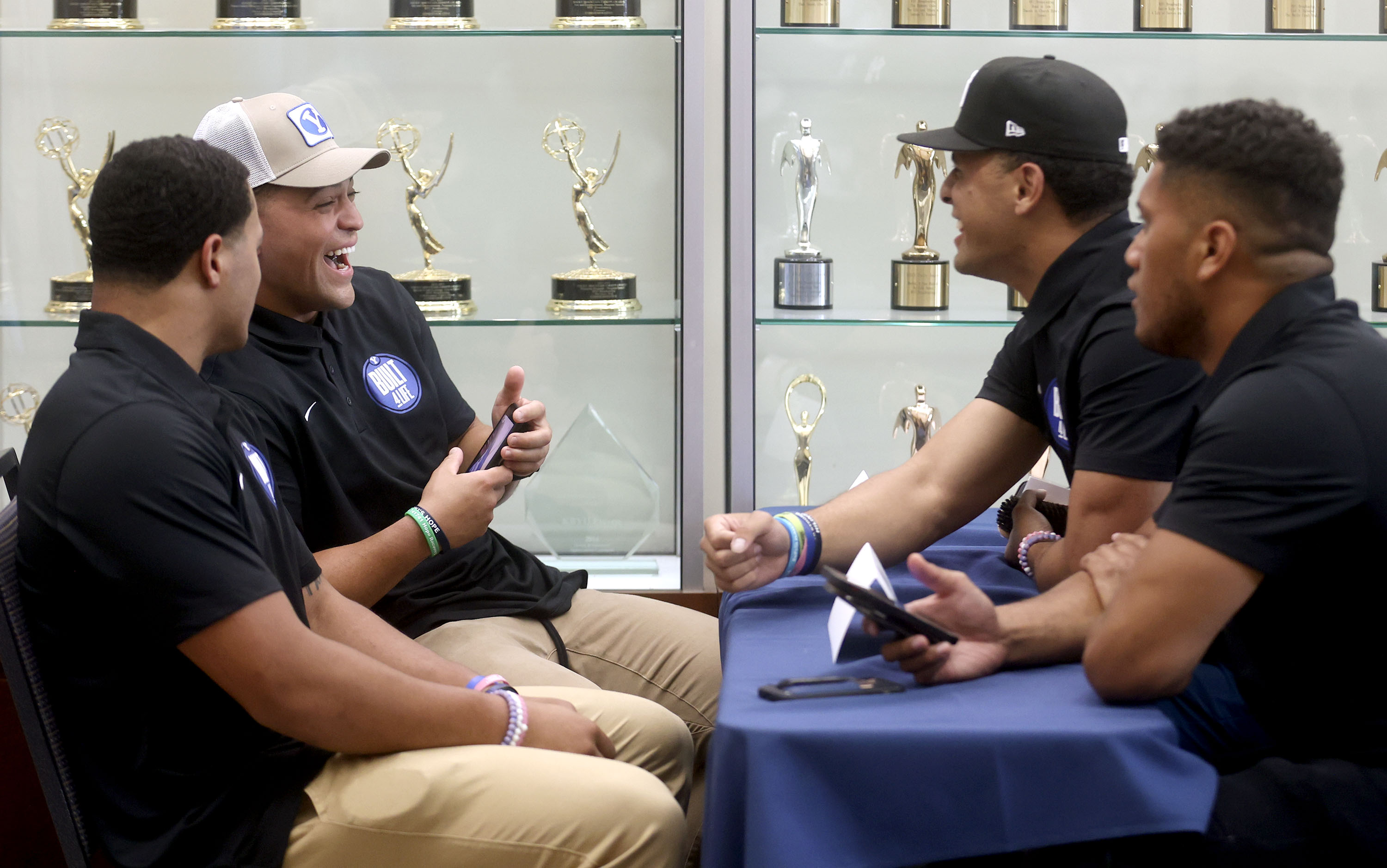 BYU running back Lopini Katoa, back left, laughs while chatting with teammates during BYU football media day at the BYU Broadcasting Building in Provo on Thursday, June 17, 2021.