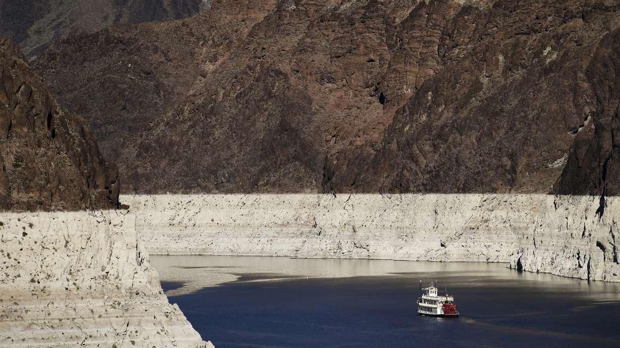 In this Oct. 14, 2015, photo, a riverboat glides through Lake Mead on the Colorado River at Hoover Dam near Boulder City, Nev. Despite drought, cities in the U.S. West expect their populations to grow considerably in the coming decades. From Phoenix to Boise, officials are working to ensure they have the resources, infrastructure and housing supply to meet growth projections.