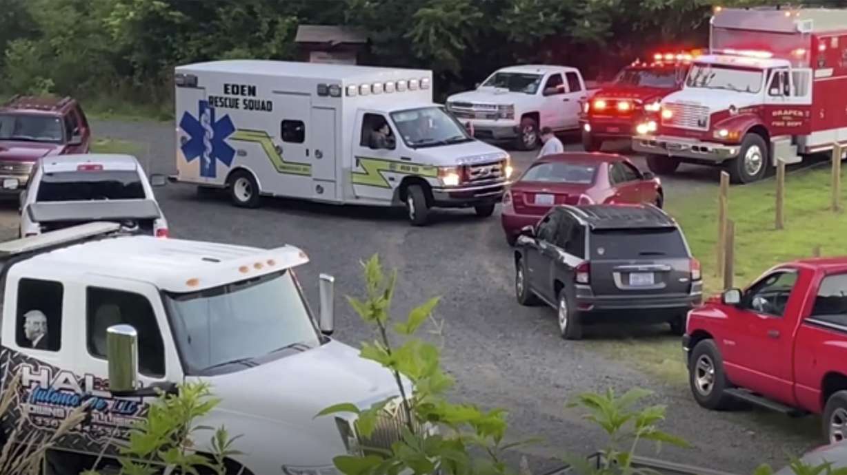 Emergency personnel respond to the scene where a group tubing on the Dan river went over a dam on Thursday, June 17, 2021 ner Eden, N.C. Rockingham County Emergency Services Director Rodney Cates said Thursday that a group of nine people were tubing on the North Carolina river and went over a Duke Energy dam in Eden around sunset Wednesday. Four people were rescued and taken to a hospital for treatment of injuries that Cates said were not life-threatening. Two more remained missing Thursday night. (WSET-TV via AP)