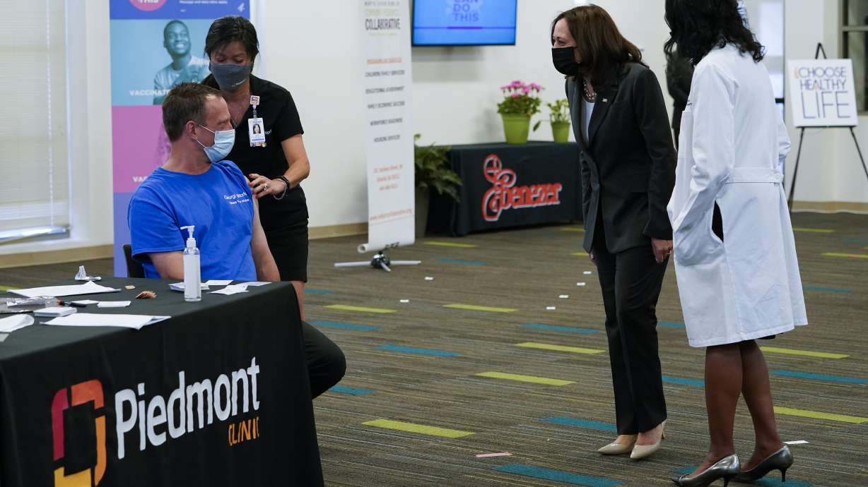 Vice President Kamala Harris talks to a man as he receives a COVID-19 vaccine at a COVID-19 pop-up center at Ebenezer Baptist Church, Friday, June 18, 2021, in Atlanta.