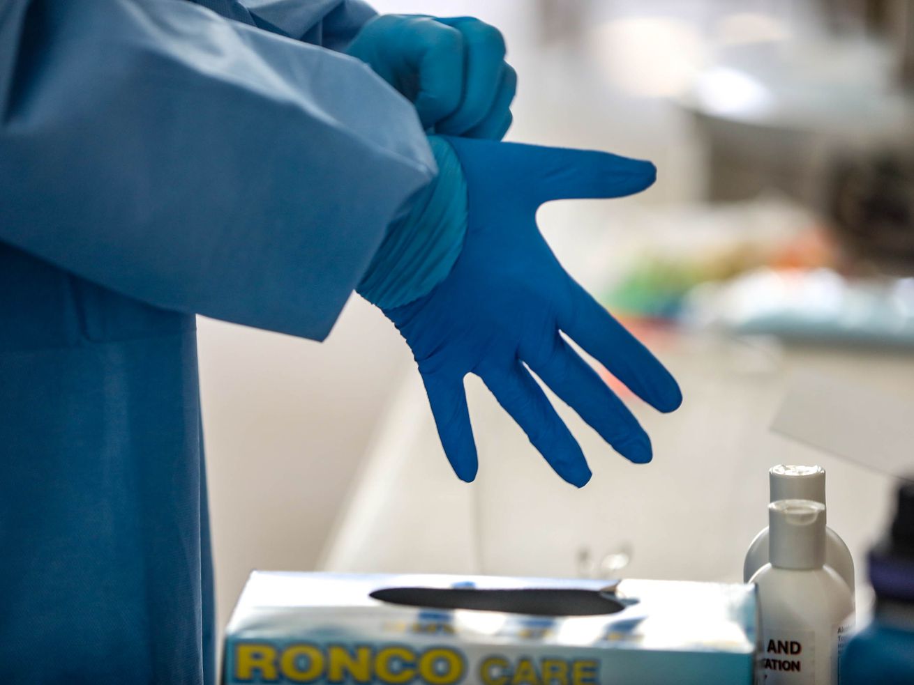 Utah National Guard Spc. Sam Sargent changes his top layer of gloves at a COVID-19 test site at the Utah State Fairpark in Salt Lake City on Monday, May 17, 2021.
