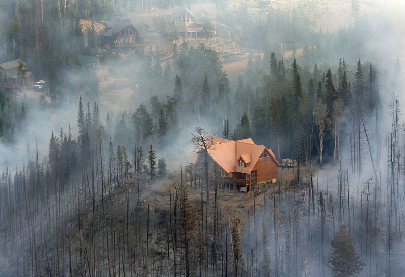 Smoke from the Brian Head Fire surrounds homes in the Brian Head area on June 23, 2017. The massive fire charred 71,673 acres, destroyed 13 homes and forced about 1,500 people to evacuate the area.