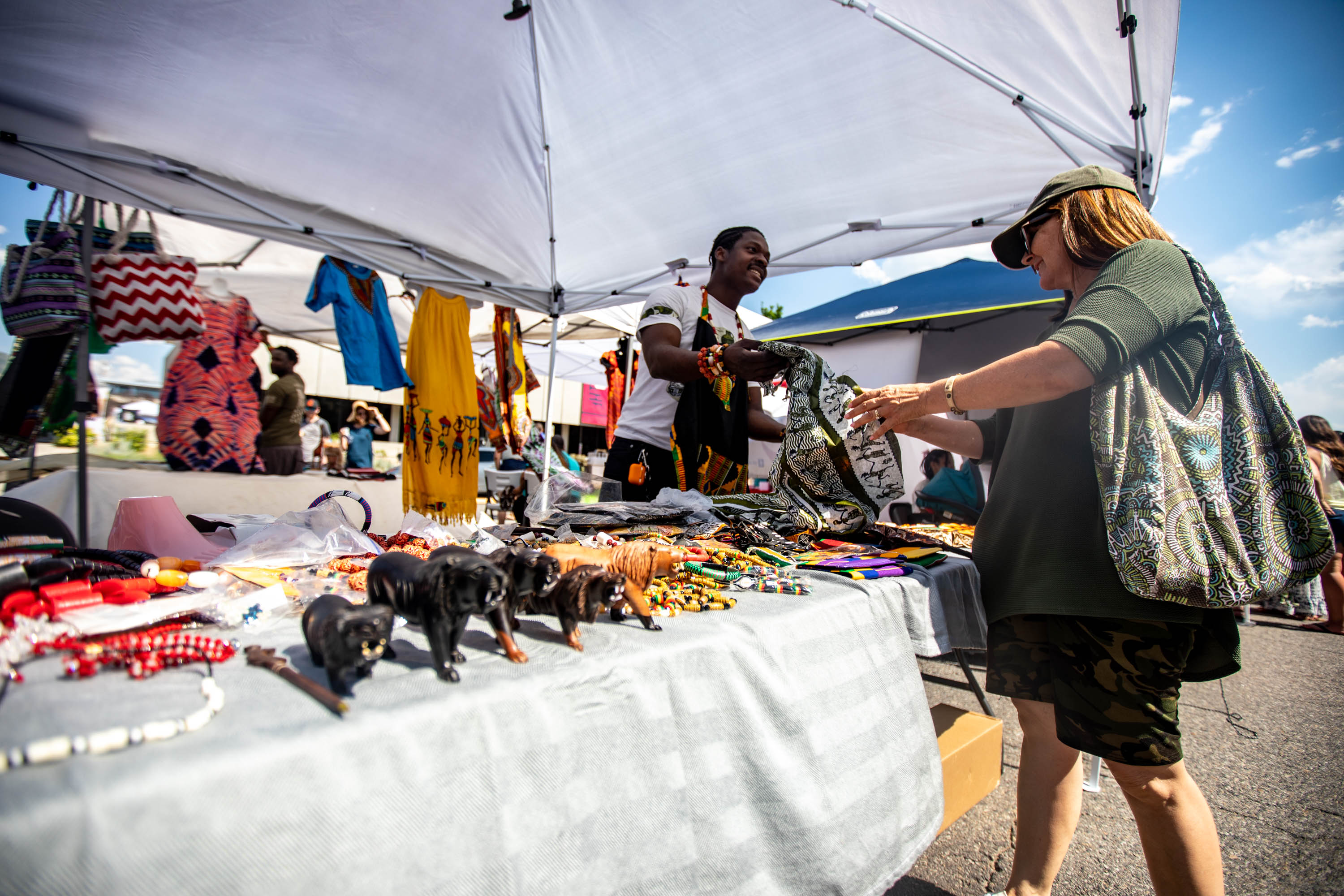 Artist Koffi Wunaki interacts with a patron during the Juneteenth event at Washington Square Park in Salt Lake City on June 19, 2021.