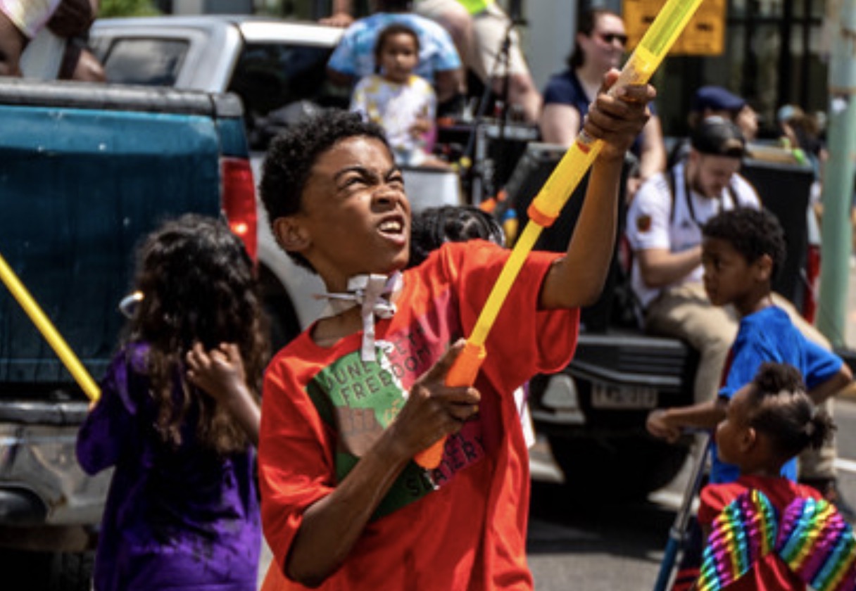 A child sprays water during the Juneteenth event at Washington Square Park in Salt Lake City on June 19, 2021.