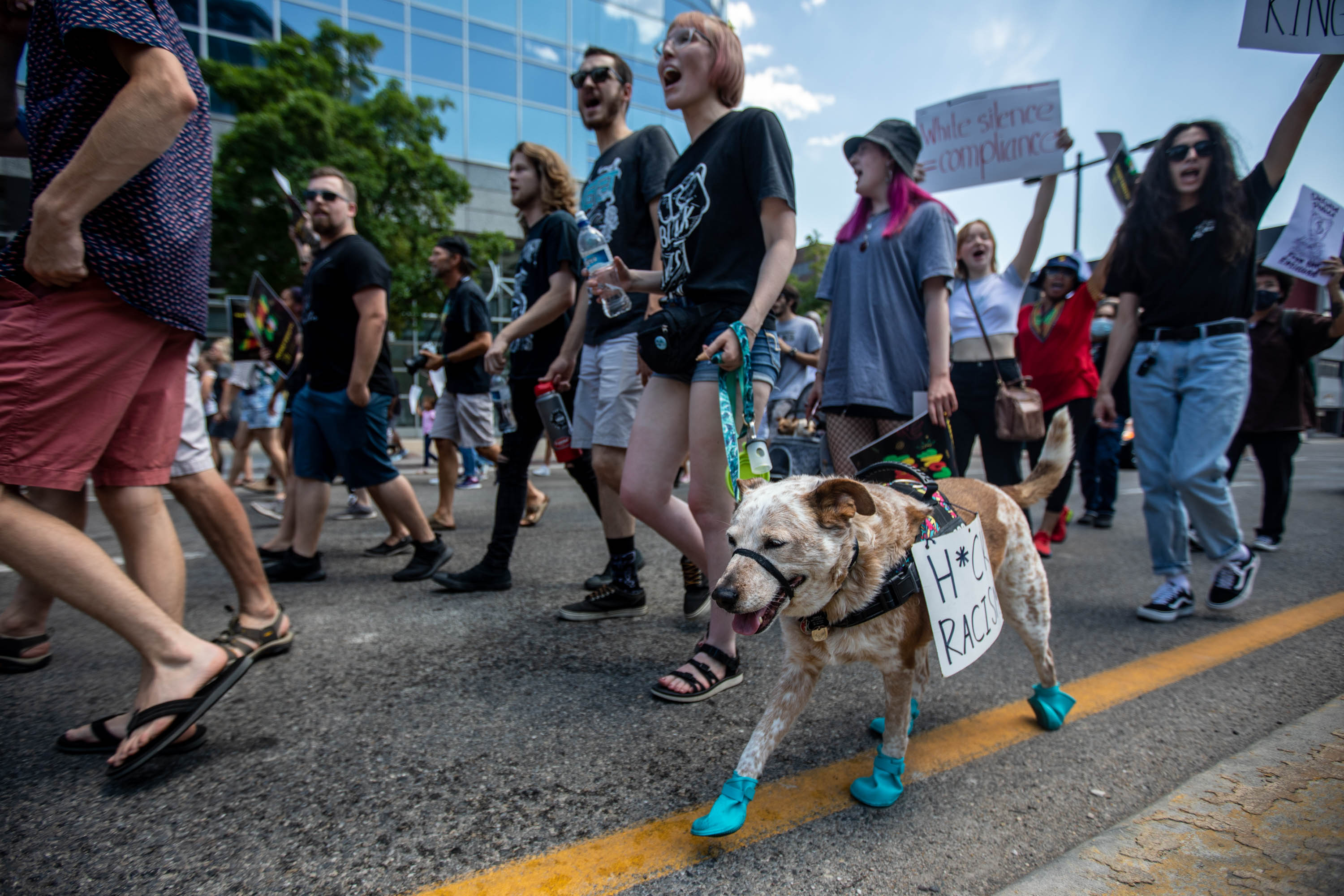 Hannah Wilhelmsen walks their dog Charlie during a Juneteenth event at Washington Square Park in Salt Lake City on June 19, 2021.
