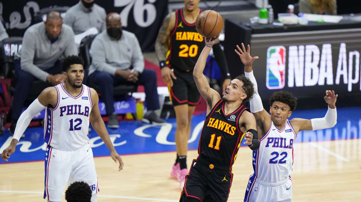 Atlanta Hawks' Trae Young (11) goes up for a shot against Philadelphia 76ers' Matisse Thybulle (22) during the second half of Game 7 in a second-round NBA basketball playoff series, Sunday, June 20, 2021, in Philadelphia.