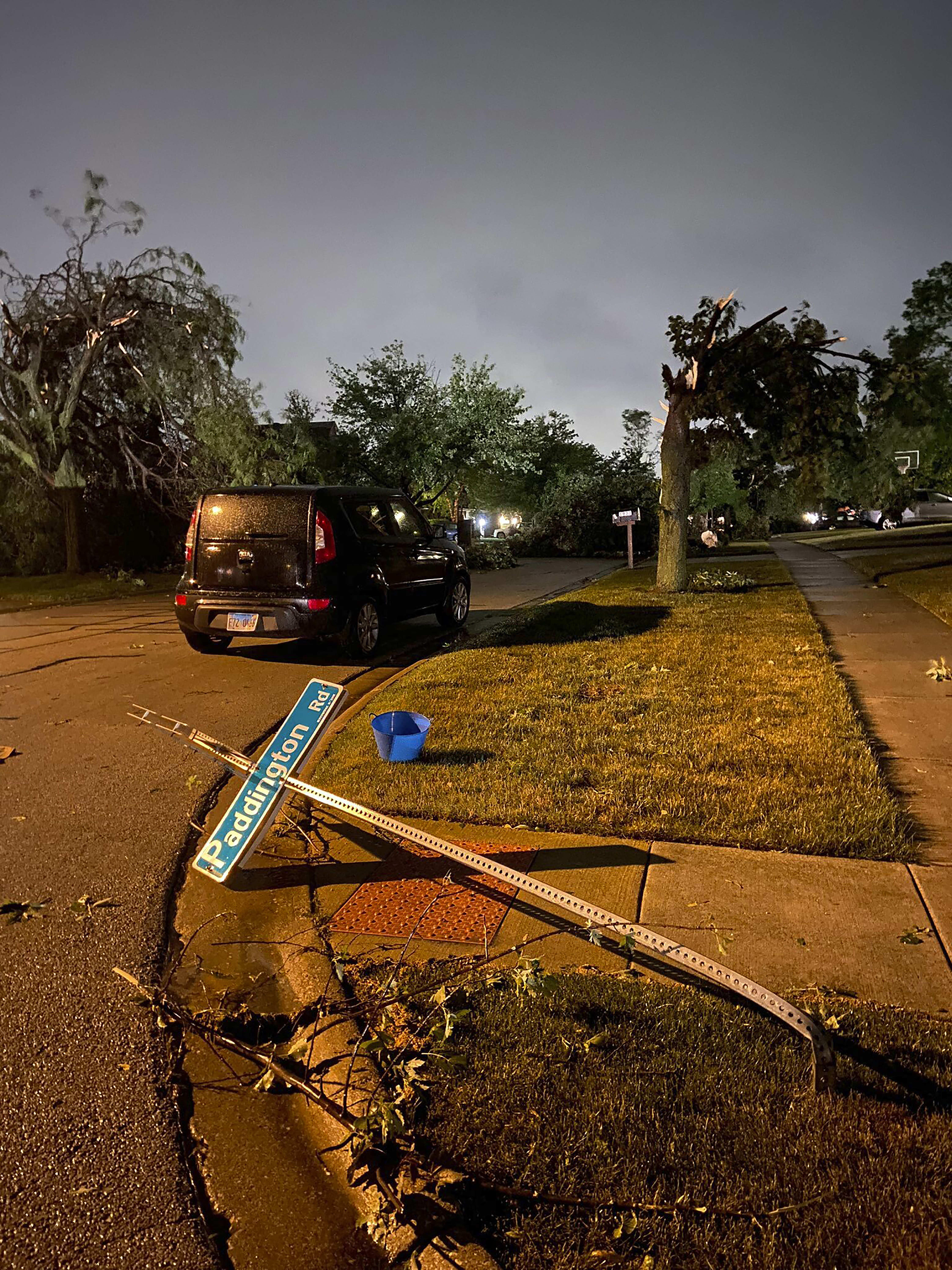 A street sign is bent over in Woodbridge, Illinois, on Monday, June 21, 2021 after the National Weather Service said a tornado was confirmed on radar on Sunday night.