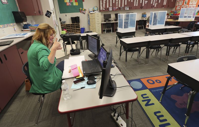 FILE: Jeni Larsen, a third grade teacher at Parkview
Elementary School in Salt Lake City, gives a thumbs up to her
students online on the first day of school in Salt Lake City on
Tuesday, Sept. 8, 2020.
