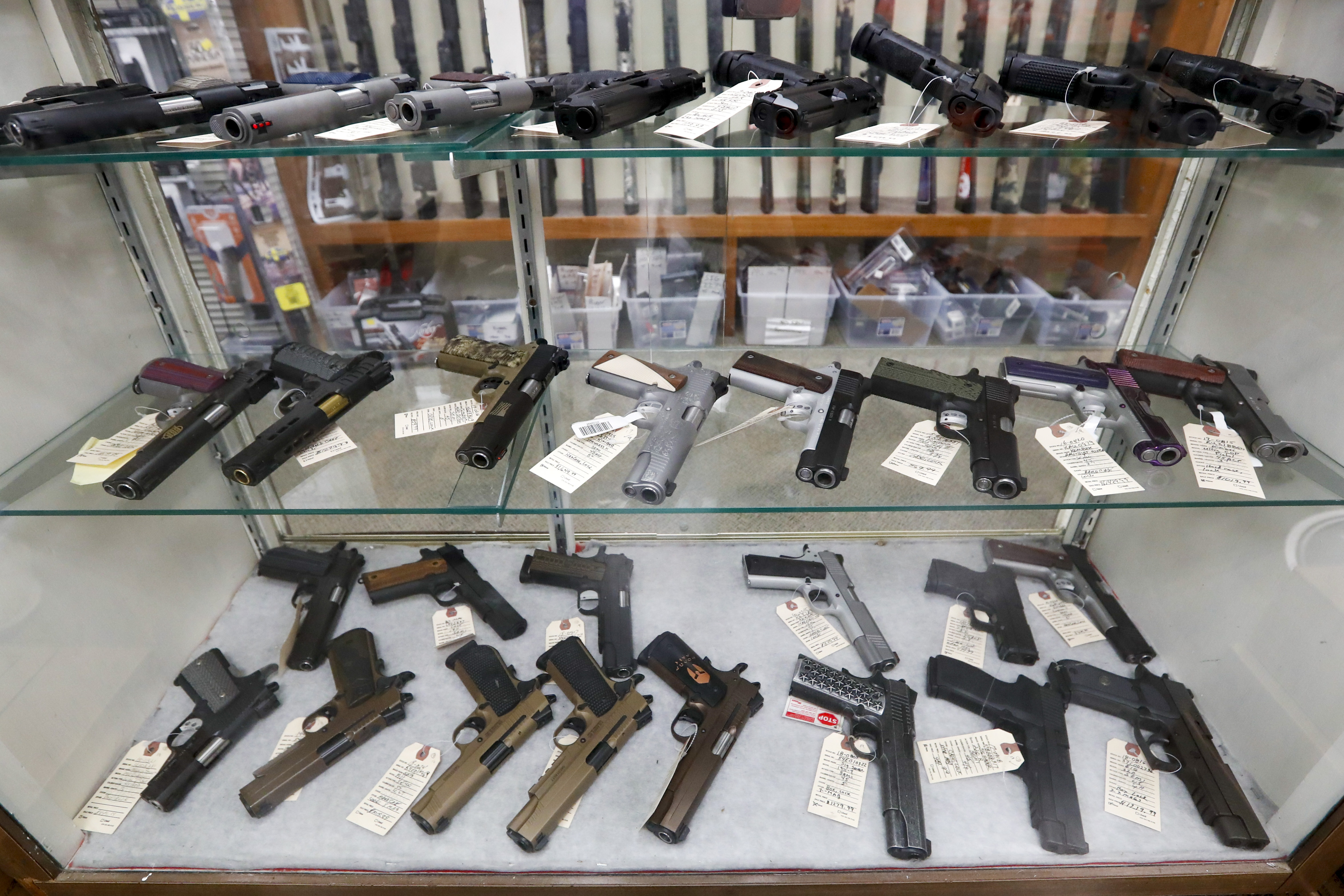 In this March 25, 2020, file photo semi-automatic handguns are displayed at shop in New Castle, Pa. The number of people stopped from buying guns though the U.S. background check system hit an all-time high of more than 300,000 last year amid a surge of firearm sales, according to new records obtained by the group Everytown for Gun Safety. The FBI numbers provided to The Associated Press show the background checks blocked nearly twice as many gun sales in 2020 as in the year before.
