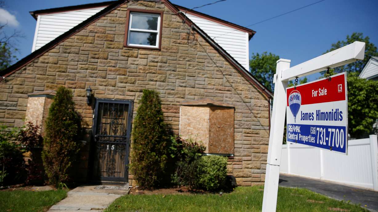 A 'for sale' is seen outside a single-family house in Garden City, New York, on May 23, 2016.