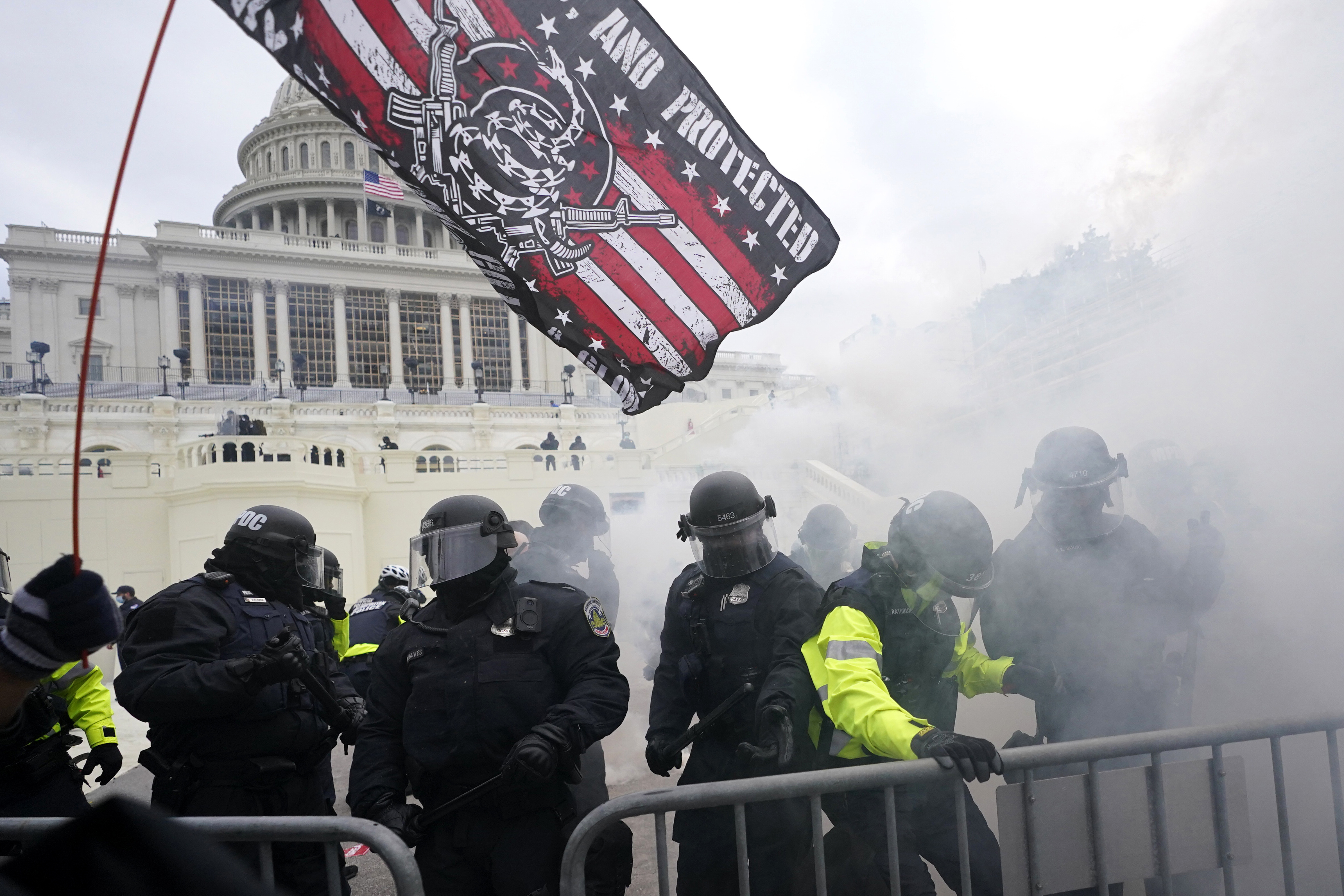Police hold off supporters of Donald Trump who tried to break through a police barrier at the Capitol in Washington on Jan. 6, 2021. House Speaker Nancy Pelosi has told Democratic colleagues that she will create a new committee to investigate the Capitol insurrection.