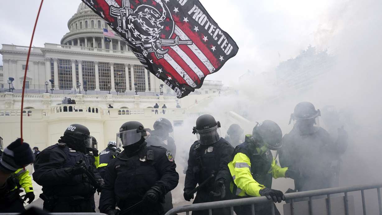 Police hold off supporters of Donald Trump who tried to break through a police barrier at the Capitol in Washington on Jan. 6, 2021. House Speaker Nancy Pelosi has told Democratic colleagues that she will create a new committee to investigate the Capitol insurrection.