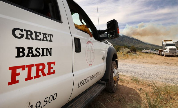 Firefighters from Great Basin Fire keep watch on a
wildfire burning on Victory Mountain in Morgan Canyon in Tooele
County on Tuesday, June 22, 2021. The fire started after a plane
crash.