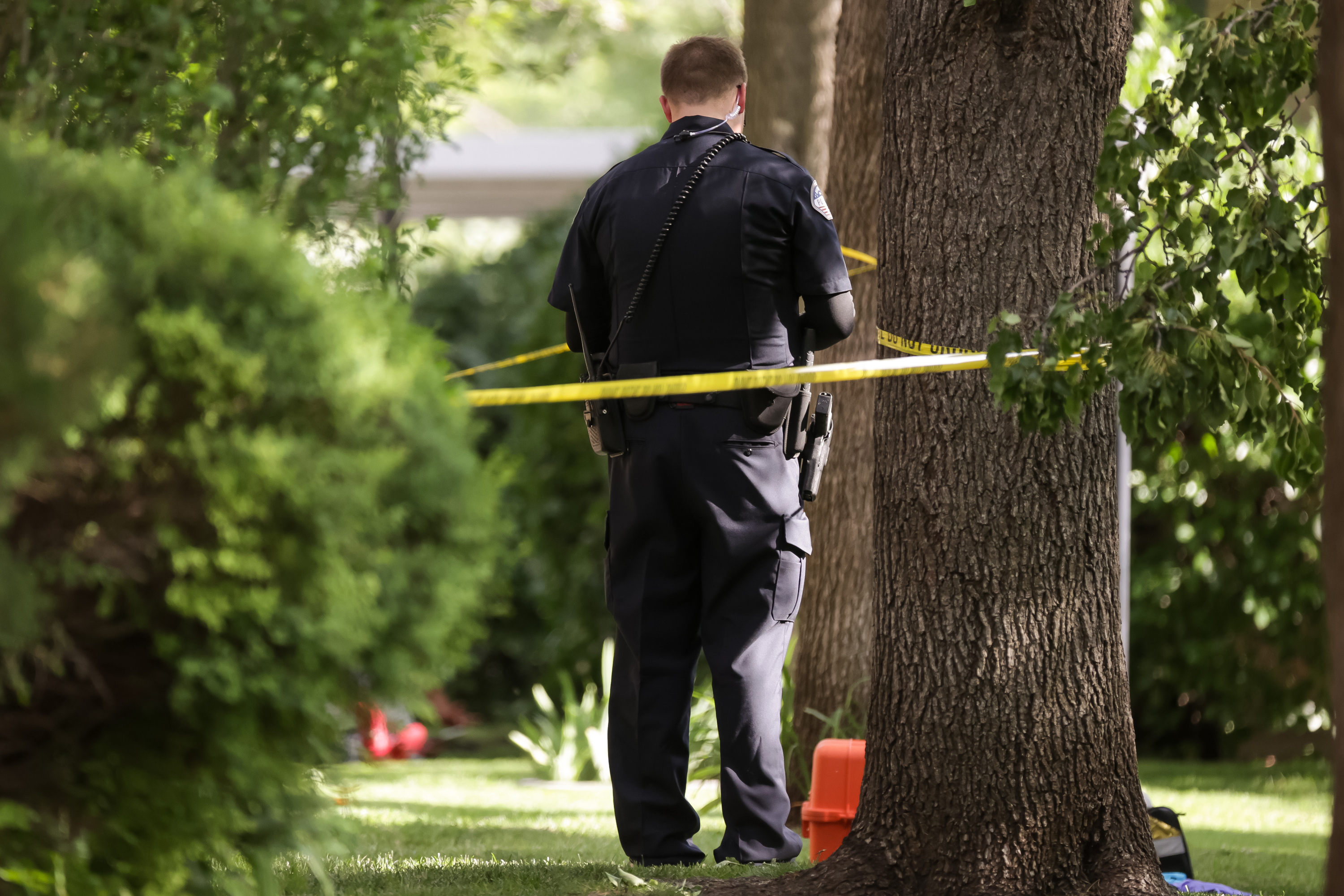 Police investigate the scene where officers shot and killed a man and an officer was shot in the leg at the Villas at Vine Apartments in Murray on Tuesday, June 22, 2021.
