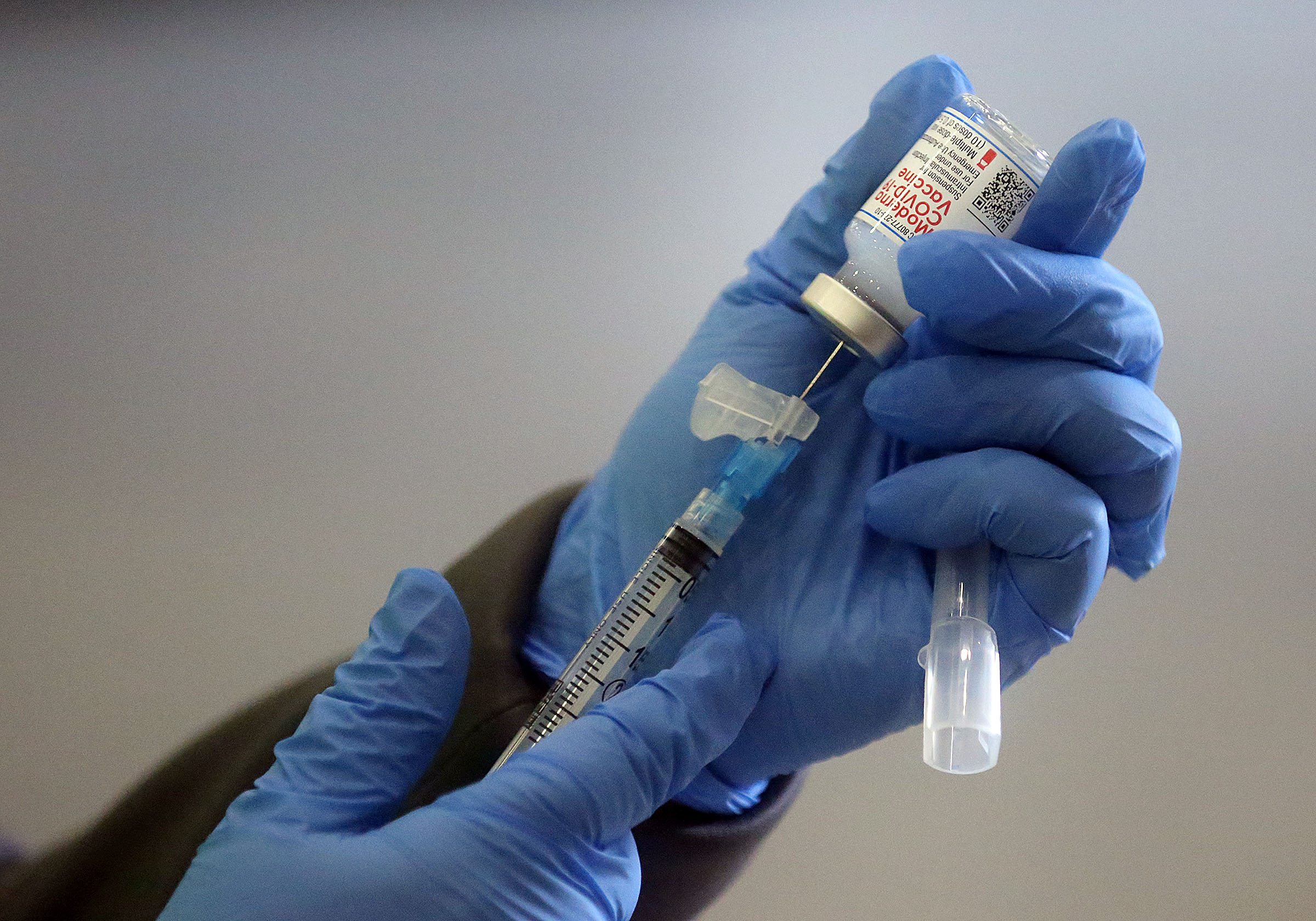 Jamie Bone, a Davis County Health Department registered nurse, prepares a syringe of Moderna COVID-19 vaccine at the Legacy Center Indoor Arena in Farmington on Jan. 12.