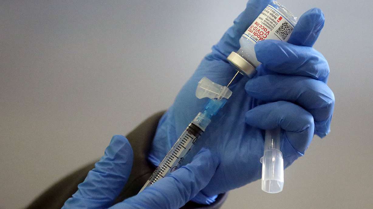 Jamie Bone, a Davis County Health Department registered nurse, prepares a syringe of Moderna COVID-19 vaccine at the Legacy Center Indoor Arena in Farmington on Tuesday, Jan. 12, 2021. Seventy percent of all Utah adults now have at least a first dose of the COVID-19 vaccine, Gov. Spencer Cox's office confirmed Tuesday.