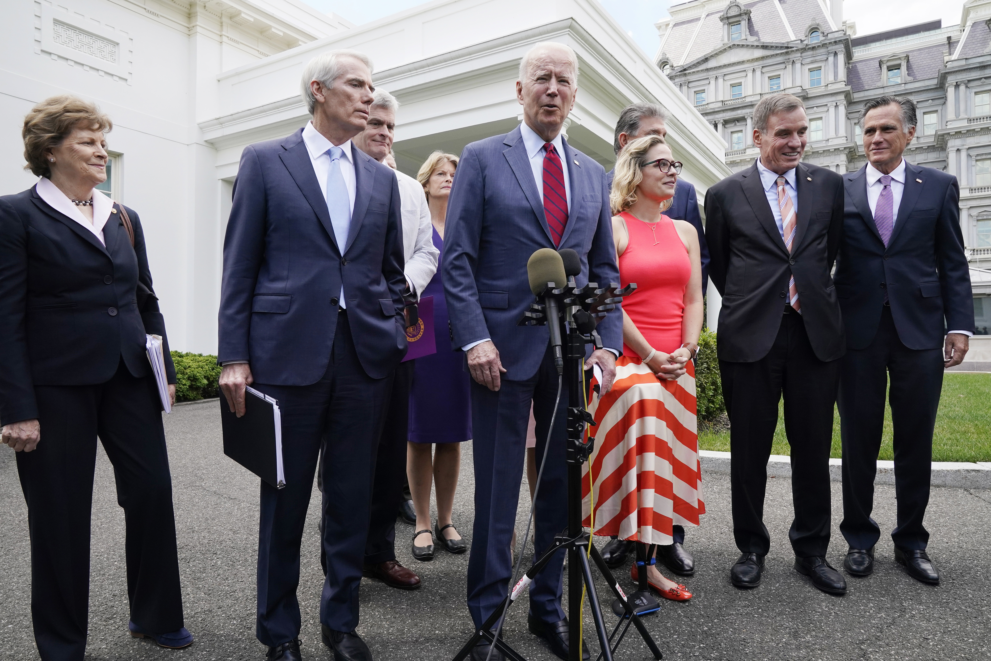 President Joe Biden, with a bipartisan group of senators, speaks Thursday, June 24, 2021, outside the White House in Washington. Biden invited 21 Republican and Democratic senators to discuss the infrastructure plan.