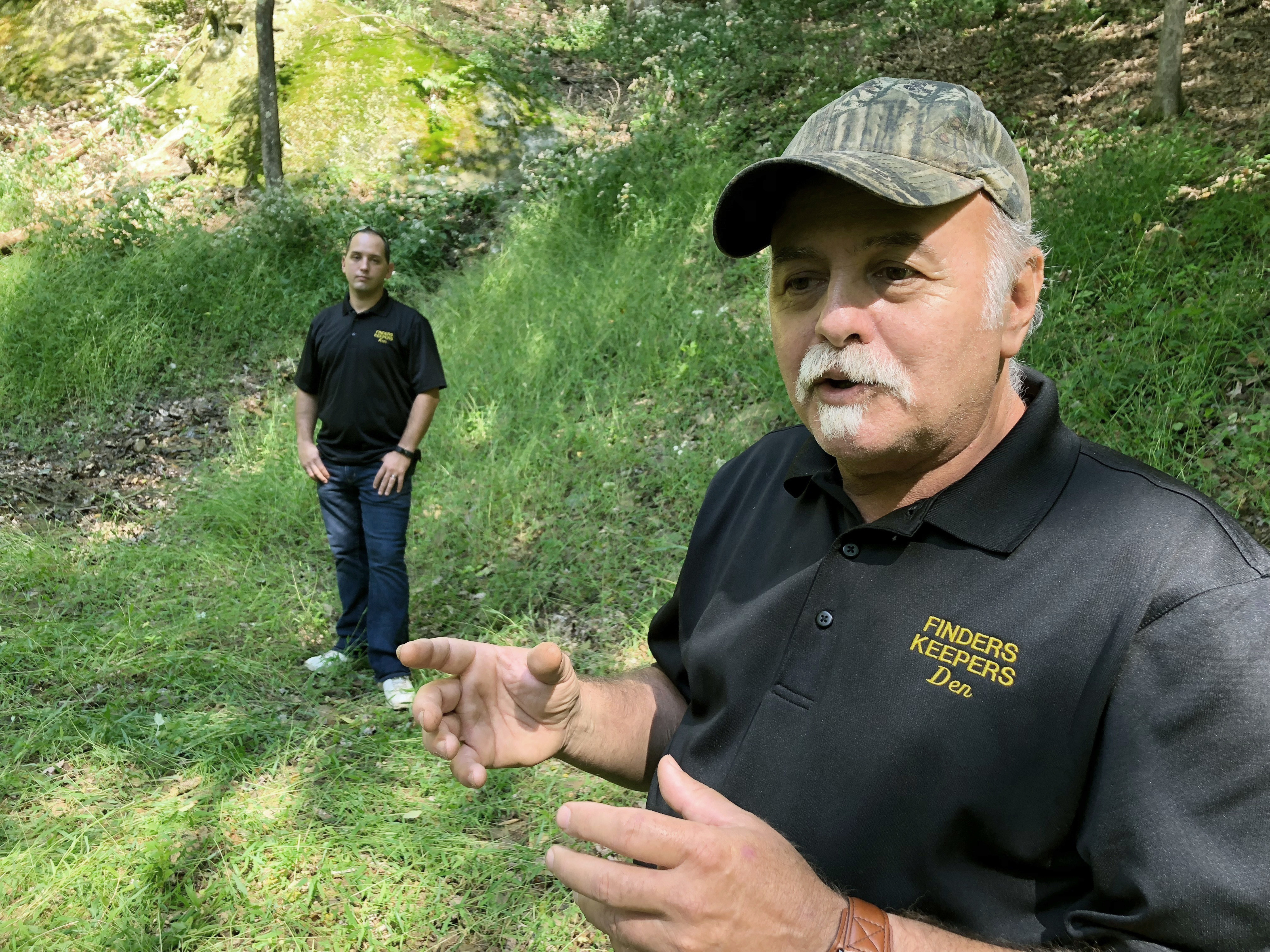 In this Sept. 20, 2018, file photo, Dennis Parada, right, and his son Kem Parada stand at the site of the FBI's dig for Civil War-era gold in Dents Run, Pa. Court documents unsealed June 24, 2021, show that an FBI agent applied for a federal warrant in 2018 to seize a cache of gold that he said had been "stolen during the Civil War" while en route to the U.S. Mint in Philadelphia.