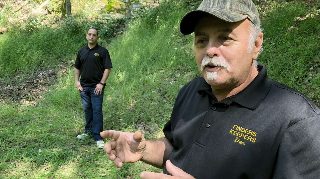 In this Sept. 20, 2018, file photo, Dennis Parada, right, and his son Kem Parada stand at the site of the FBI's dig for Civil War-era gold in Dents Run, Pa. Court documents unsealed June 24, 2021, show that an FBI agent applied for a federal warrant in 2018 to seize a cache of gold that he said had been "stolen during the Civil War" while en route to the U.S. Mint in Philadelphia.