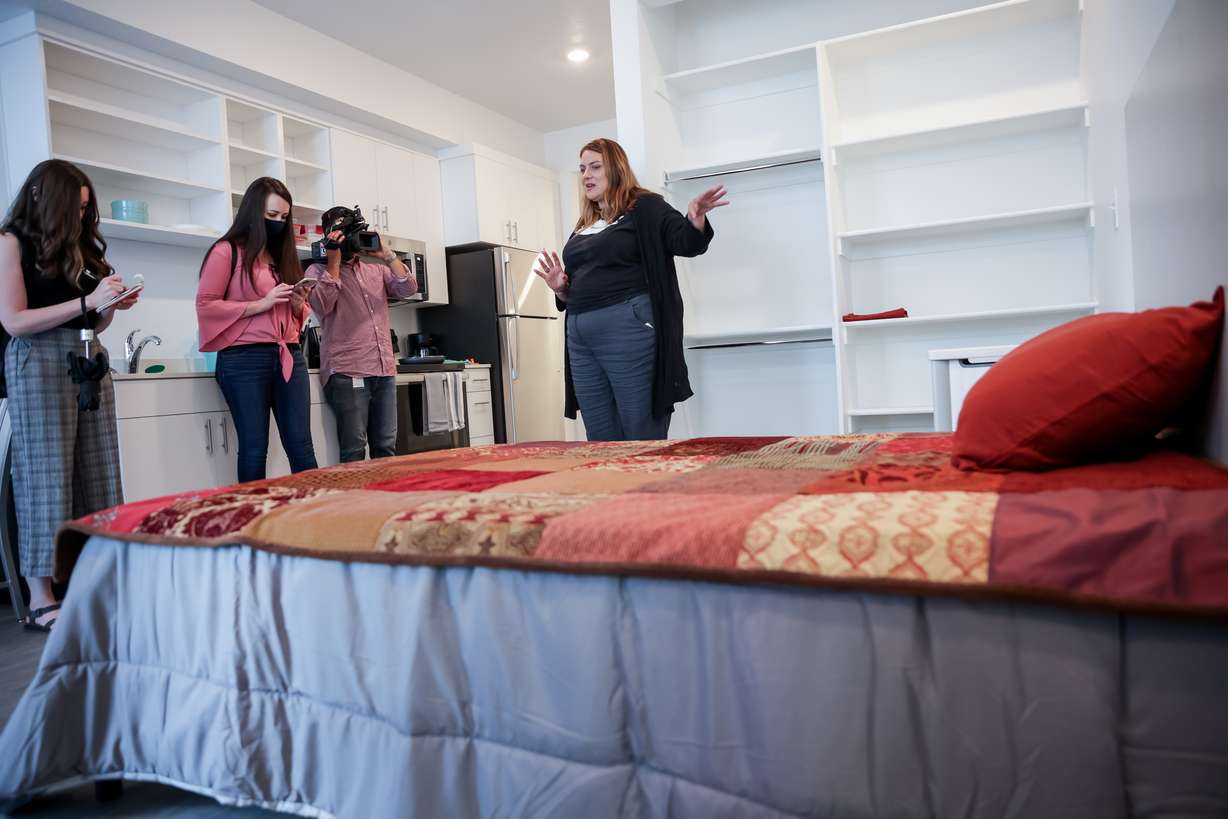 Michelle Flynn, executive director of The Road Home, right, gives a tour of Magnolia, a new permanent supportive housing building, during its opening celebration in Salt Lake City on Thursday, June 24, 2021. The new building, owned by Shelter the Homeless and operated by the Road Home, has 65 units for people who have experienced homelessness.