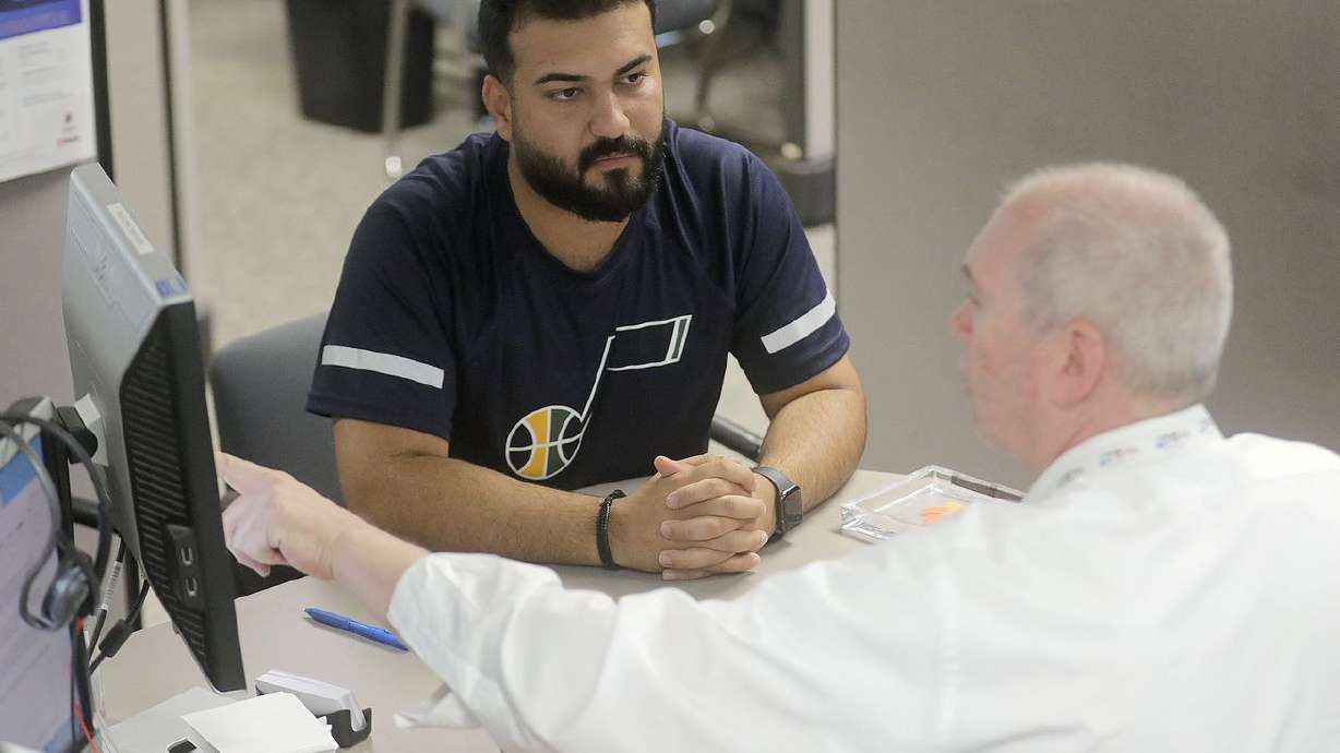 Omar Shukur meets with B.BK Keown, an employment counselor with the Utah Department of Workforce Services, during an initial assessment meeting at the department’s offices in Salt Lake City on Tuesday, June 22, 2021. Utah is ending pandemic-related federal jobless benefits Saturday for some 24,000 Utahns, two months ahead of the deadline.