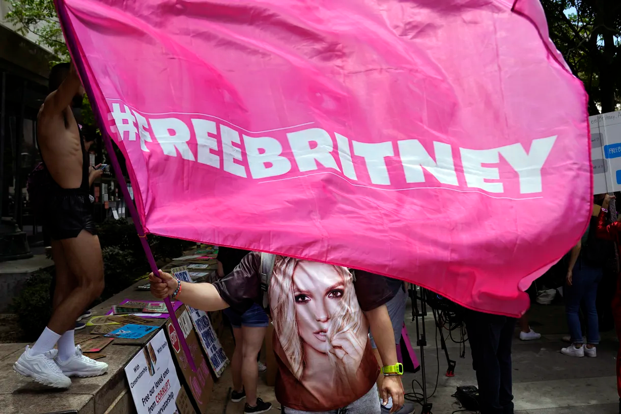 A Britney Spears supporter waves a “Free Britney” flag outside of a court hearing concerning the pop singer’s conservatorship at the Stanley Mosk Courthouse on Wednesday, June 23, 2021, in Los Angeles.