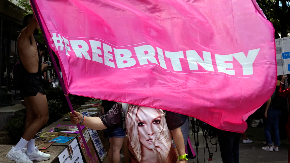 A Britney Spears supporter waves a “Free Britney” flag outside of a court hearing concerning the pop singer’s conservatorship at the Stanley Mosk Courthouse on Wednesday, June 23, 2021, in Los Angeles.