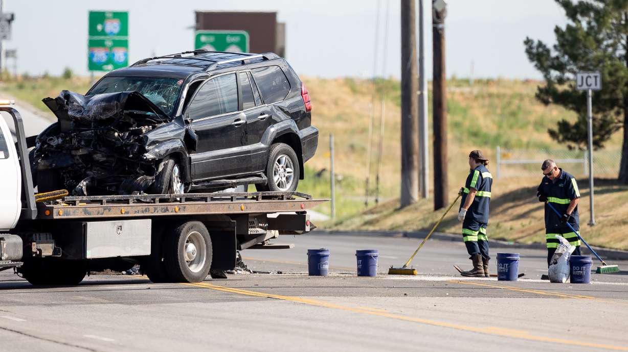 Crews clean up after a fatal collision on 5600 West near 2200 South in West Valley City on Friday, June 25, 2021. Police say a 16-year-old boy and a 52-year-old man have died from injuries sustained during the head-on collision.