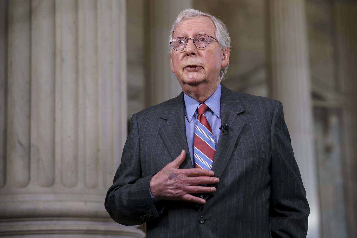Senate Minority Leader Mitch McConnell, R-Ky., does a cable news interview before the start of a two-week recess, at the Capitol in Washington, Wednesday. Earlier, President Joe Biden announced a bipartisan agreement on a pared-down infrastructure plan that would make a start on his top legislative priority and validate his efforts to reach across the political aisle.