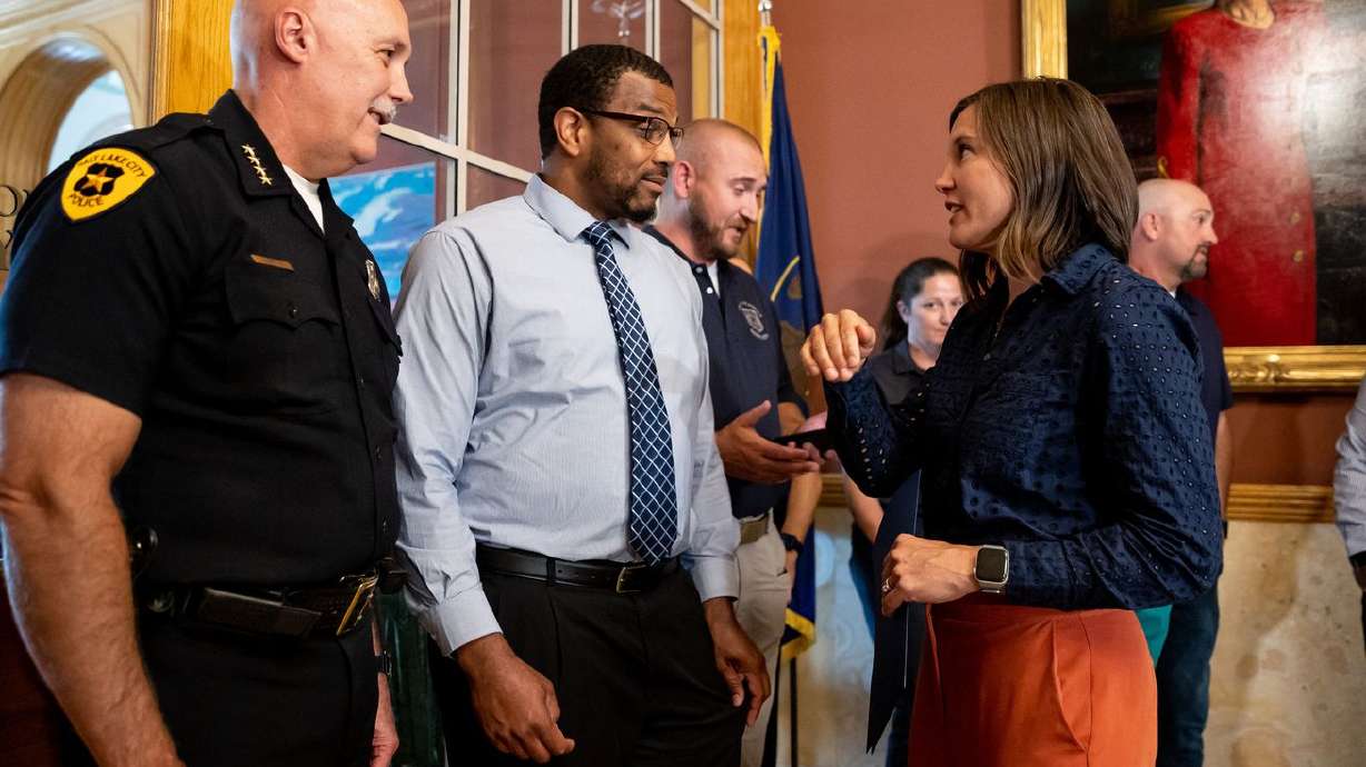 Salt Lake City Police Chief Mike Brown, left, Kamaal Ahmad, a member of the city’s Commission on Racial Equity in Policing, and Mayor Erin Mendenhall talk after she announced pay increases for the city’s union employees, including police and fire, at the Salt Lake City-County Building on Friday, June 25, 2021.