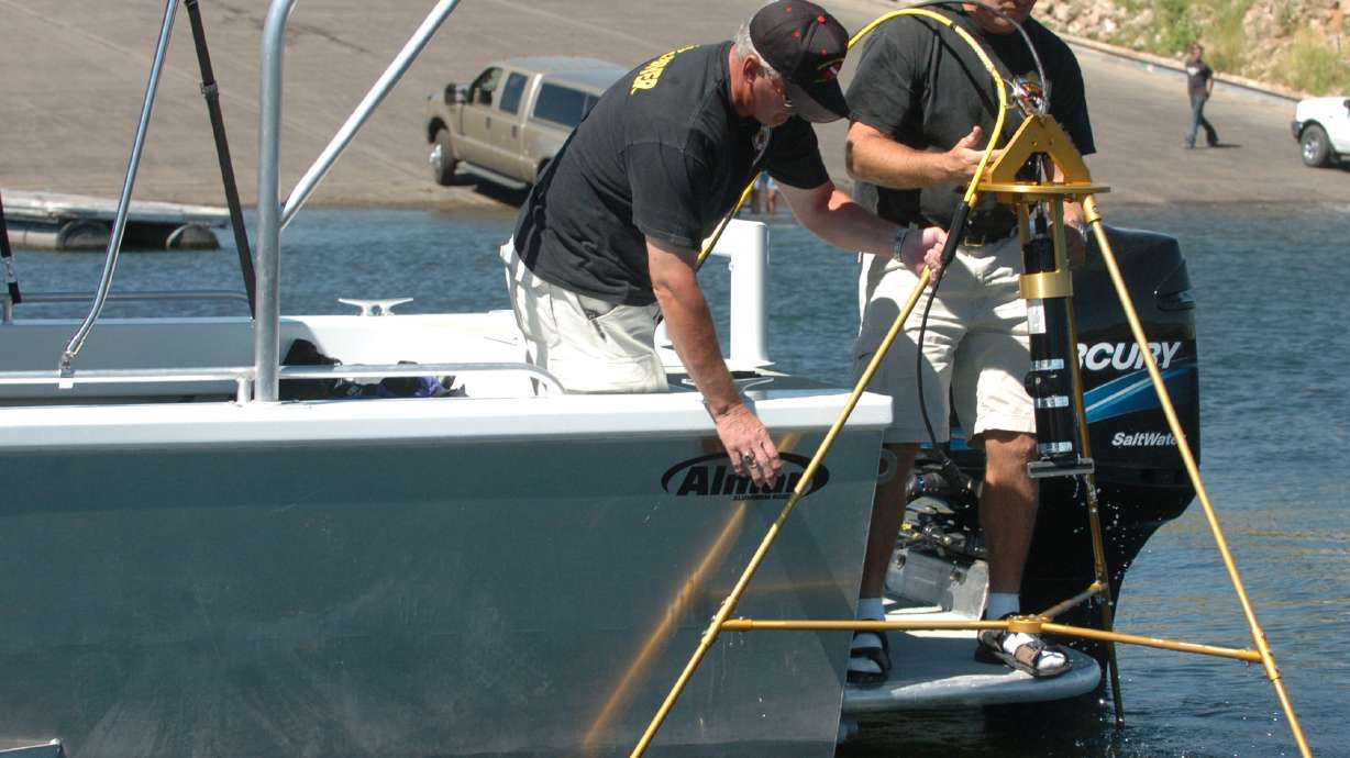 Public safety officials on Strawberry Reservoir retrieve an underwater sonar used to locate drowning victims in this file photo from July 28, 2005. After four drownings at state parks last week, officials say there is one step that could help prevent most drownings.