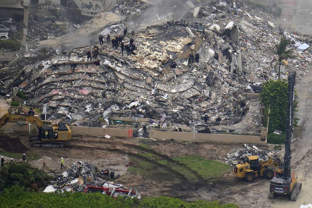 In this aerial image search and rescue workers work the site of an oceanfront condo building that partially collapsed, in Surfside, Fla., Friday, June 25, 2021. Miami-Dade Mayor Daniella Levine Cava says rescue officials are continuing to search Friday and there's still hope of finding survivors in the rubble more than 24 hours after the building collapsed.