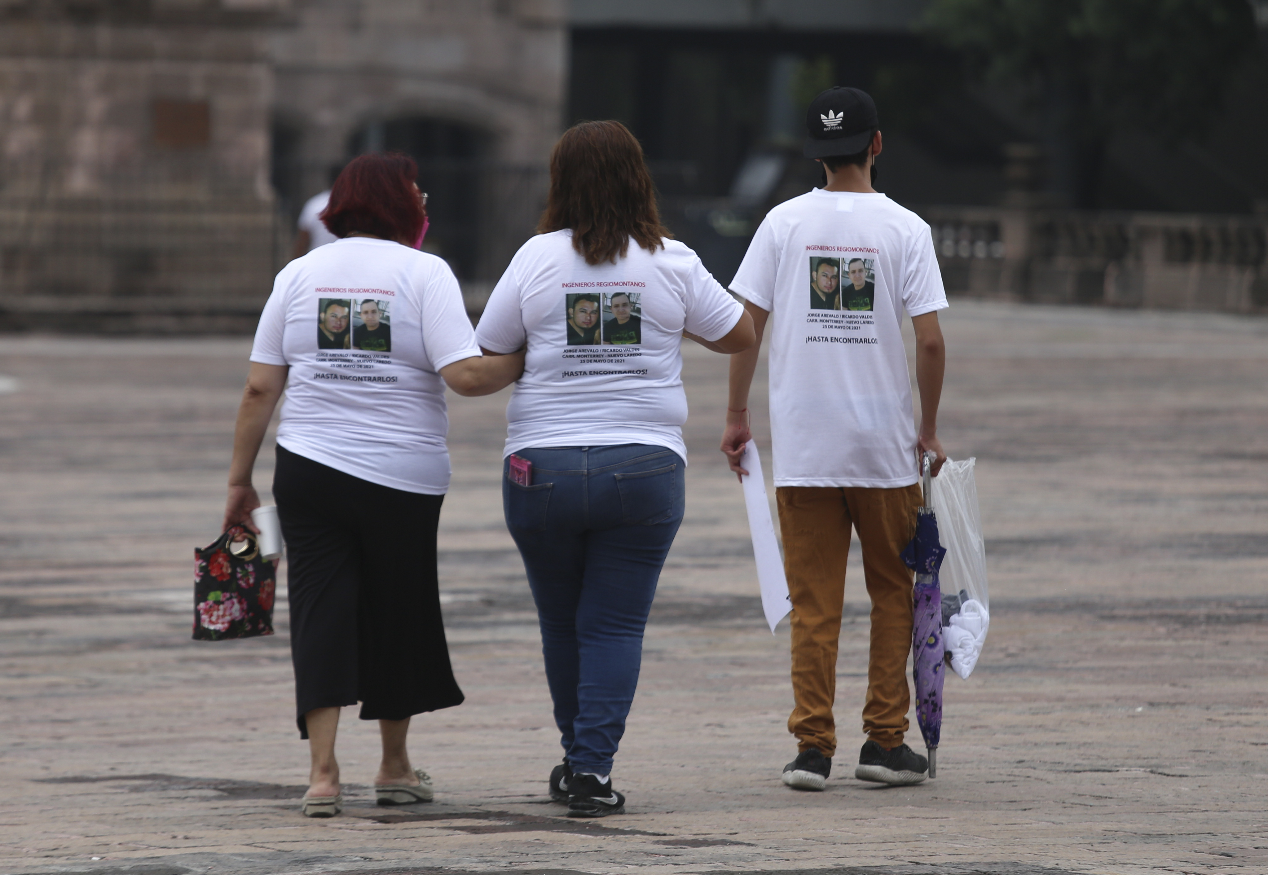 Family members wear T-shirts with photos of disappeared Jorge Arevelo and Ricardo Valdes, during a protest in Monterrey, Nuevo Leon state, Mexico, Thursday, June 24, 2021.