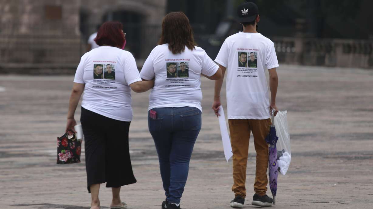 Family members wear T-shirts with photos of disappeared Jorge Arevelo and Ricardo Valdes, during a protest in Monterrey, Nuevo Leon state, Mexico, Thursday, June 24, 2021.