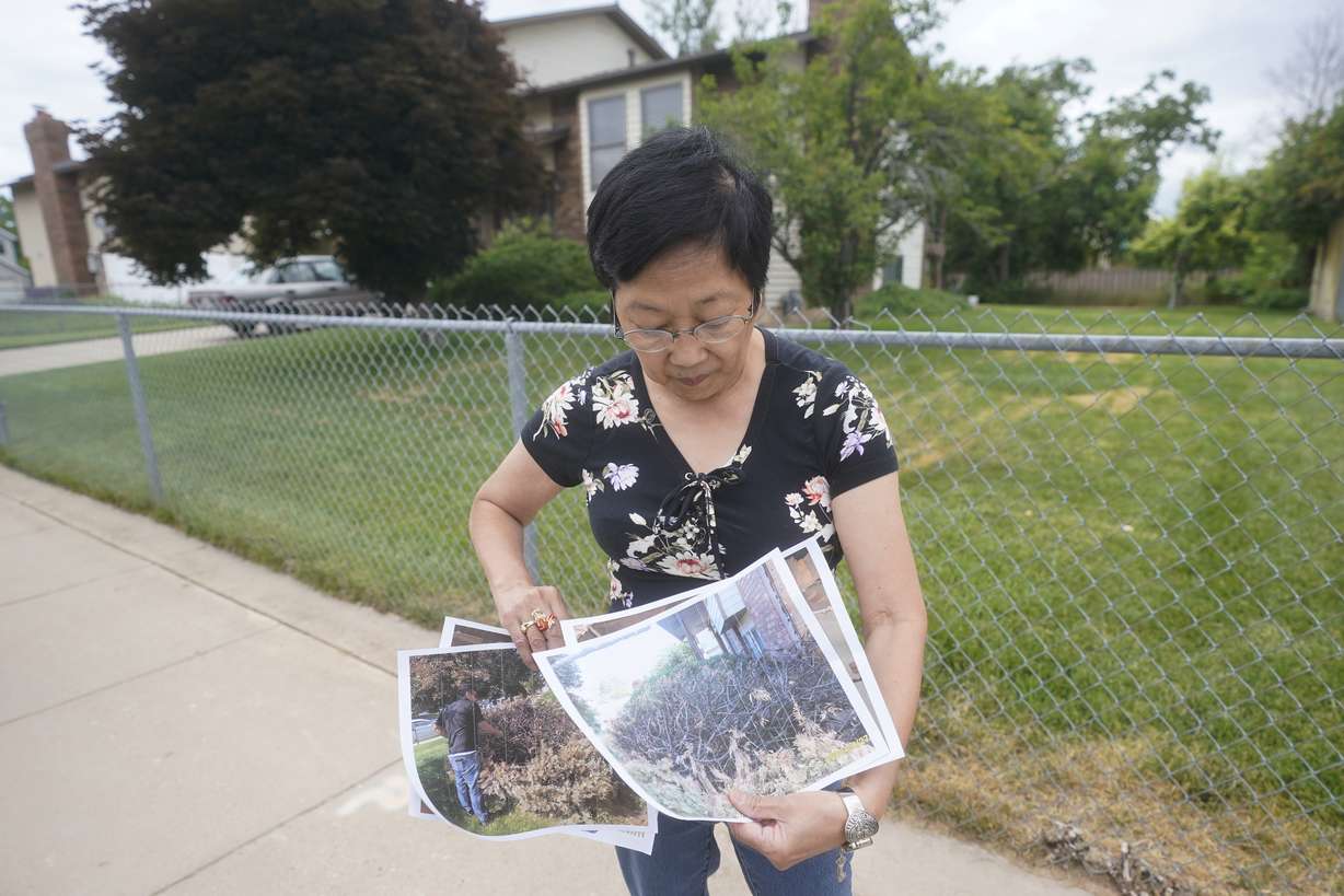 Bobbie Uno displays photographs of burnt brushes outside her home Thursday, June 24, 2021, in Clearfield, Utah. Fireworks carry risk, starting thousands of fires a year, including an incident that burned Uno's home on the holiday last year.