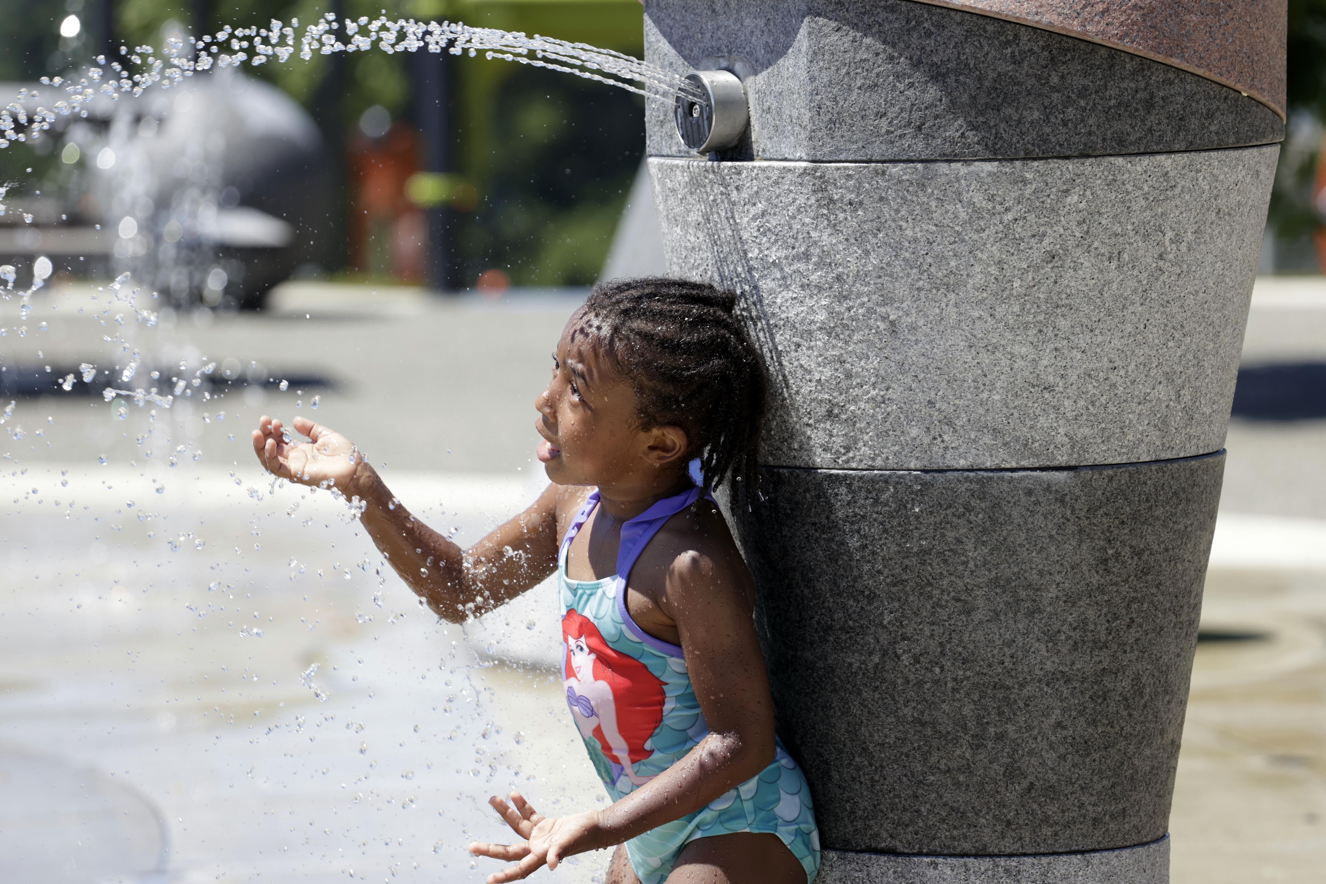 Mellena O'Brien, 4, plays in the Yesler TerraceSpray Park during a heat wave hitting the Pacific Northwest, Sunday, June 27, 2021, in Seattle.