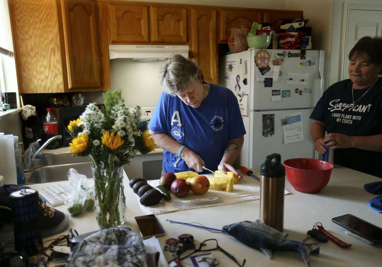 Susan Munsell-Beck and Sherry Munsell prepare dinner at their Clinton home on Tuesday, June 15, 2021. Munsell-Beck is a chef and Munsell is a truck driver. When they first moved into a three-bedroom, two-bathroom house in Clinton about three years ago, their rent cost $1,345. Now, it costs about $1,550 a month, including insurance.